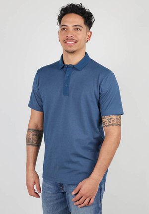Polo shirt pour homme à manches courtes en bleu foncé, avec une patte de boutonnage, un col standard et un tissu texturé au style ajusté.