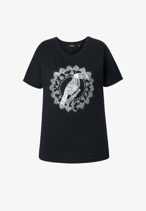 T-shirt noir à manches courtes avec un dessin au trait blanc détaillé d'un toucan perché sur une branche entouré d'un motif floral circulaire décoratif.