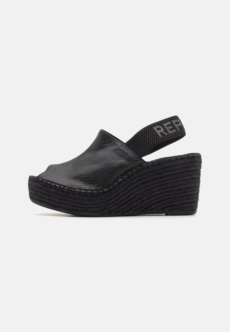 Sandale compensée noire avec dessus en cuir grainé et bride arrière élastique étiquetée "REP" sur fond blanc.