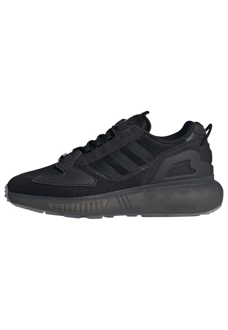 Black athletic sneakers made with mesh and synthetic materials. Features three black stripes, textured accents, and a rubber sole.