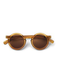 Round sunglasses with transparent amber frame and dark brown lenses. Features curved bridge and wide arms, offering a modern design.