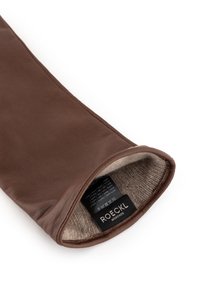 Brown leather glove with a soft textile lining, featuring a label with care instructions and brand name. Smooth exterior and neat stitching.