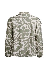 Long-sleeved shirt in lightweight fabric, featuring a green floral pattern on a white background. Rounded collar and gathered cuffs.