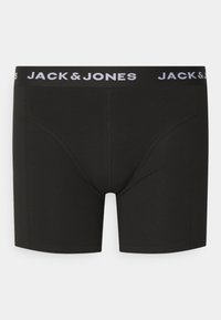 Boxers noirs en tissu doux avec une coupe ajustée. Dotés d'une ceinture élastique blanche avec le logo "JACK & JONES" imprimé.