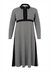 Schwarz-weißes Hahnentwist-Midi-Kleid mit langen Ärmeln, Reißverschluss auf der Vorderseite, schwarzem Kragen und schwarzen vertikalen Einsätzen an den Seiten und der Taille.