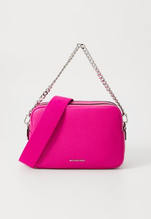 Pink leather crossbody bag with a textured finish, featuring a silver chain strap and a fabric shoulder strap. Zippered top, logo on front.