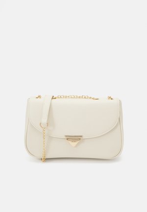Cream-colored rectangular handbag with gold triangular clasp and gold chain strap on plain white background.