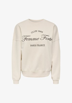 Bež pulover z okroglim izrezom in dolgimi rokavi z rdečim črnim napisom »Club 1986 Femme Forte Paris France« na sprednji strani.