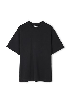 T-shirt en coton noir à manches courtes, col rond et fentes sur les côtés à l'ourlet. Design simple, sans motifs ni embellissements visibles.