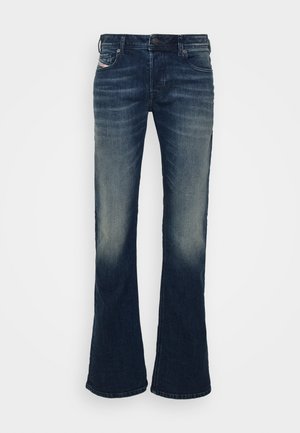 Tumed sinine denim flared teksad, hägune pesu, viie taskuga disain, metallnööbiga sulgur ja kontrastõmblused.