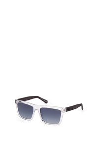 Gafas de sol de plástico transparente con lentes gris degradado y brazos negros. El diseño presenta una forma cuadrada y un sutil detalle del logo en la montura.