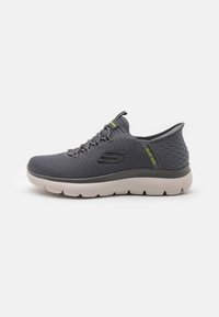 Gray athletic shoe featuring breathable mesh upper, lace-up design, and textured heel. White cushioning sole with a black accent logo.
