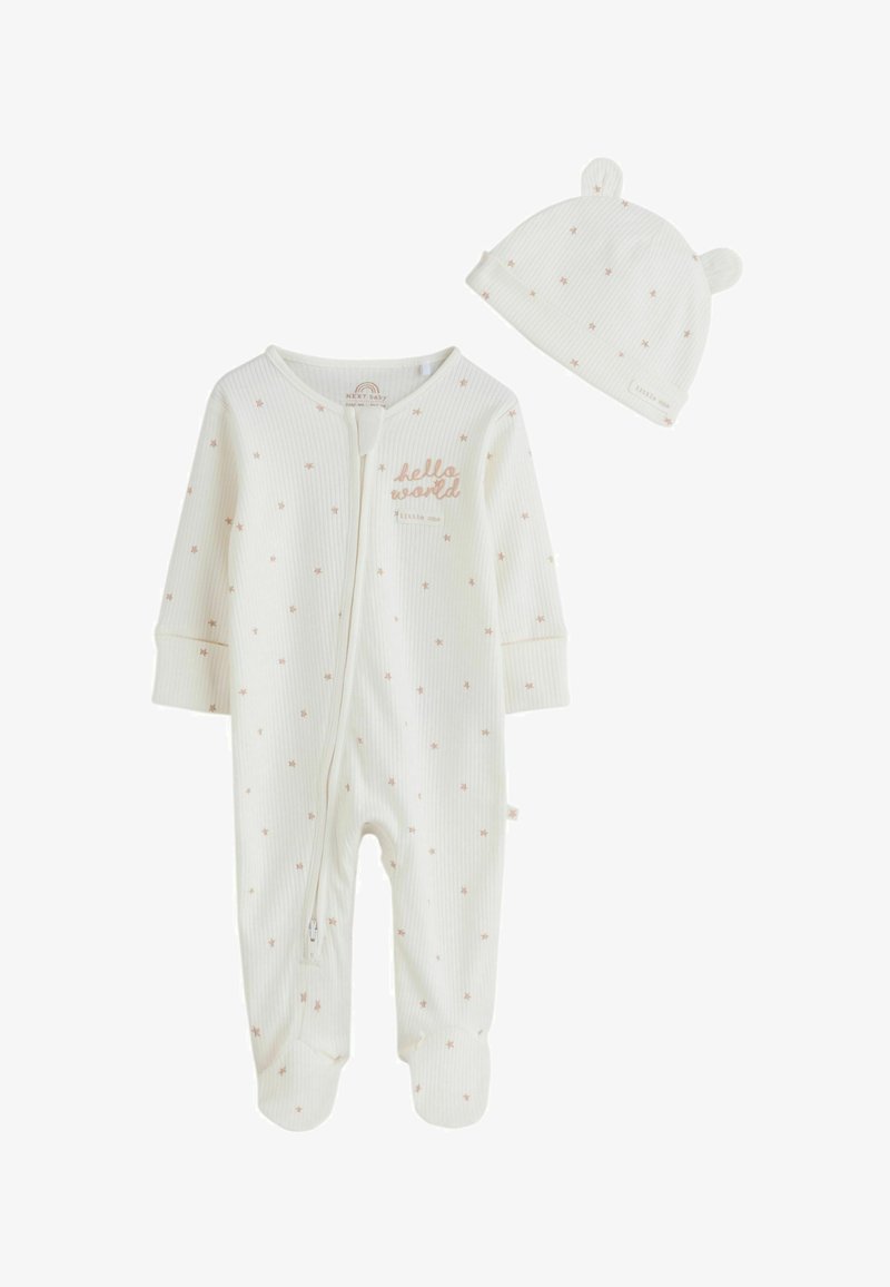 Body bébé blanc côtelé avec motif d'étoiles beige et fermeture éclair à l'avant, assorti d'un chapeau avec des oreilles d'ours et imprimé d'étoiles.