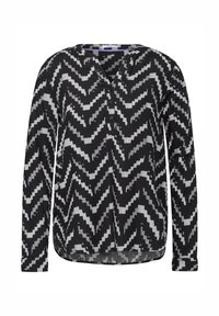 Blusa a maniche lunghe in bianco e nero con motivo a zigzag, dotata di scollatura a V e abbottonatura, realizzata in un tessuto leggero e con orlo curvo.
