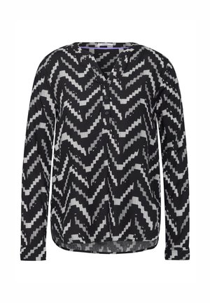 Langarm blouse in zwart en wit met een zigzagpatroon, voorzien van een V-hals en knopenlijst, van lichtgewicht stof en met een gebogen zoom.