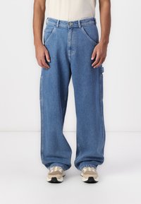 Light blue denim jeans with a relaxed fit, featuring deep side pockets, a button closure, and a classic five-pocket design.