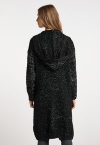 Sort strikket lang cardigan med hætte, der har et tekstureret design og ribbede manchetter og kant. Blødt stof med en subtil glimmer-effekt.