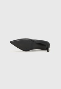 Scarpa nera con tacco alto, punta affusolata, tomaia in pelle liscia e tacco sottile e curvo. La suola è piatta e strutturata per una buona presa.