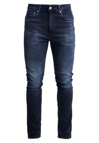 Mörkblå denimjeans med slim fit-design. Har fem fickor, blekta områden på låren och standard knappr och dragkedja.