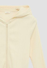 Lichtbeige ritsvitten hoodie gemaakt van ribbelstof. Beschikt over een capuchon, een voorkant rits en een zachte textuur. Eenvoudig ontwerp zonder patronen.