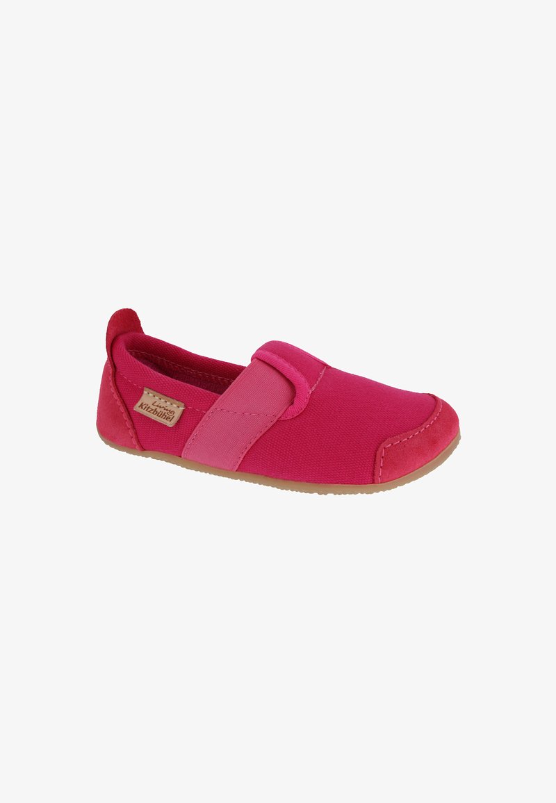 Pink slip-on shoe made of canvas with a smooth texture and suede accents. Features a rubber sole and overlapping color panels.