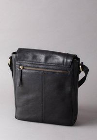 Black leather messenger bag with a zippered front pocket, a smooth finish, flap closure, and an adjustable strap. Dimensions not specified.