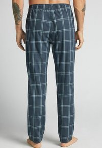 Męskie bawełniane spodnie piżamowe w kratę w kolorze granatowym z jasnoniebieskim wzorem, z elastycznym pasem i luźnym krojem, o prostym fasonie i bez kieszeni.