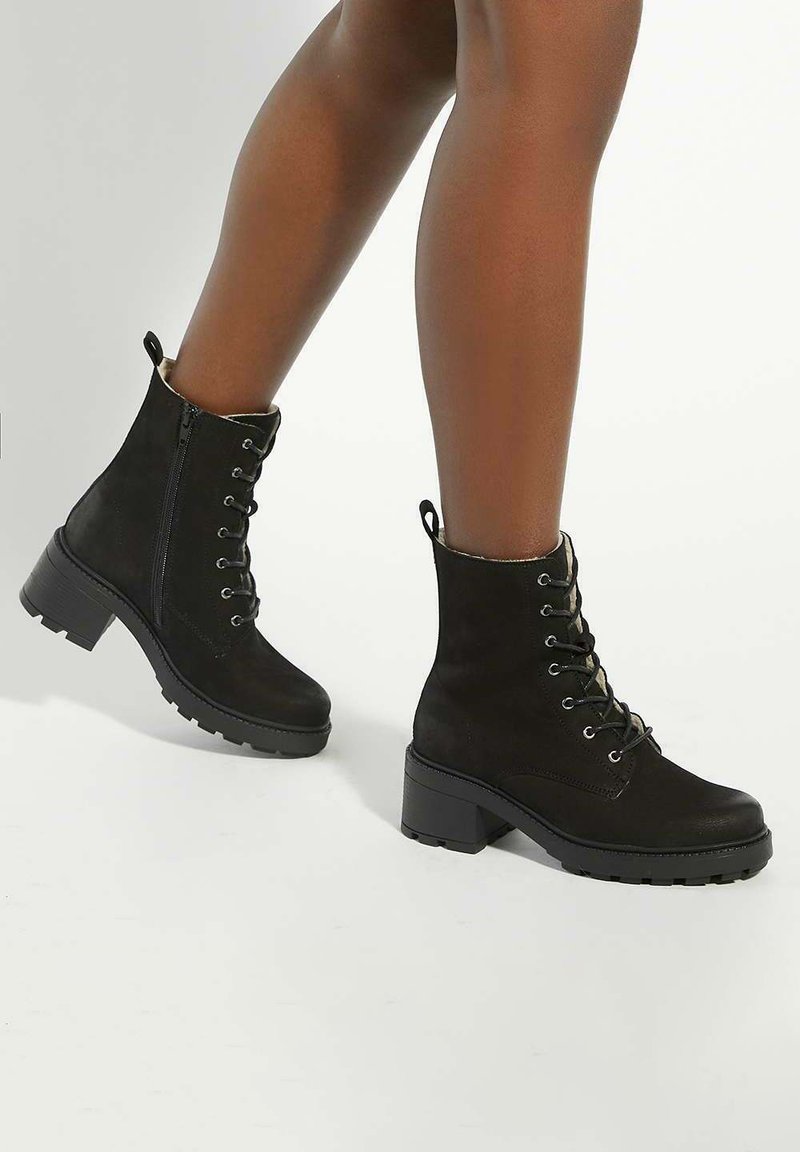 Black suede ankle boots with a lace-up front, side zipper, and chunky heel. Textured sole for grip and a soft lining.