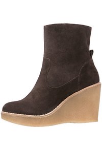 Brown suede ankle boot with a high wedge heel, featuring a smooth texture and a curved shape. Simple design, no embellishments.