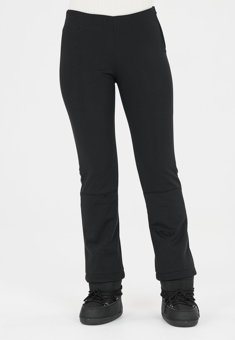Black, fitted pants made of soft, stretch fabric with a smooth texture. The design features a tailored fit and flared bottom.