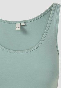 Lichtgroene mouwloze tanktop met een ronde hals. Gemaakt van een zacht katoenmixmateriaal, met een gladde textuur en een eenvoudig ontwerp.
