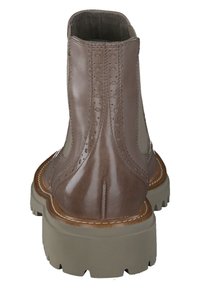 Braune Lederstiefel bis zu den Knöcheln mit glatter Oberfläche, dekorativen Broguemuster und dicker Gummisohle. Mit abgerundeter Zehenpartie und erhöhtem Absatz.