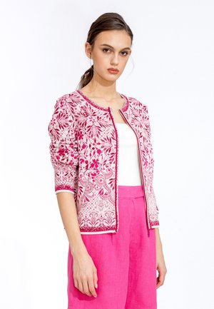 Pink embroidered cardigan with floral patterns, round neckline, three-quarter sleeves, and a smooth texture, paired with pink trousers.