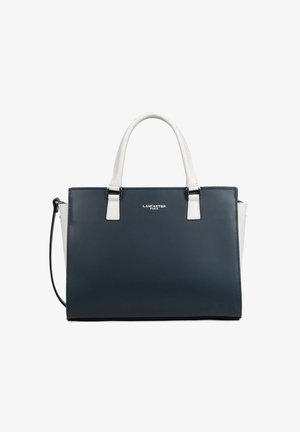 Sac à main en cuir bleu marine et blanc avec deux poignées blanches, fermeture éclair latérale et logo « Lancaster Paris » centré sur le panneau avant.