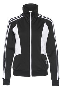 Černá a bílá sportovní bunda s vysokým límcem, plnou délkou zipu a třemi bílými pruhy na rukávech a stranách. Obsahuje vyšívané logo.