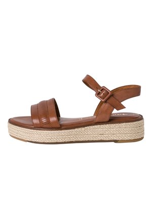 Sandales plateforme en cuir marron avec deux larges bretelles et une fermeture à boucle. Elles présentent une semelle intermédiaire en jute tissé et une semelle lisse et plate.