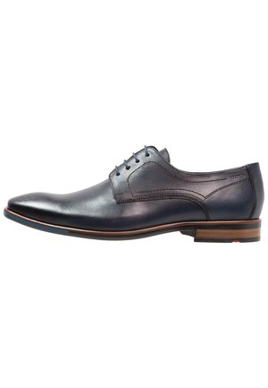 Navy blue leather dress shoe with smooth finish, pointed toe, and five eyelet lacing; subtle accent stitching and wooden heel detail.