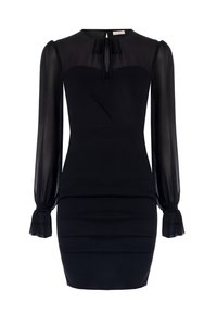 Robe noire avec des manches longues en transparent, un corsage ajusté et un décolleté structuré. Présente un nœud décoratif à l'arrière et des accents froncés.