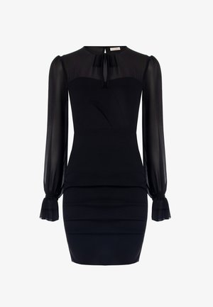 Black dress with sheer long sleeves, a fitted bodice, and a structured neckline. Features a bow tie detail at the back and ruched accents.