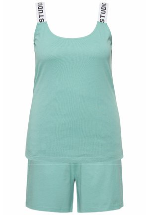 Mint green tank top and shorts set made of soft fabric. Tank features thick straps with "STUDIO" text. Simple, relaxed fit with no patterns.