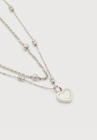 Ασημένιο στρωματοποιημένο κολιέ με στρογγυλές χάντρες και μία καρδιόσχημη κρεμαστή με χαραγμένο το όνομα της μάρκας και την ημερομηνία.