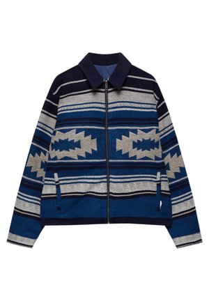 Herre jakke med lynlås og blå, marineblå og grå horisontale og geometriske mønstre, med krave og to forlommer.