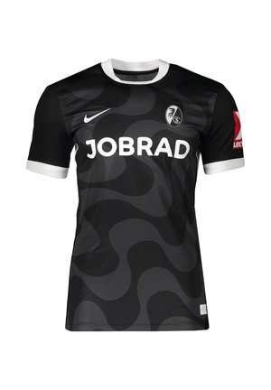 Sort og mørkegrå bølget mønstret fodboldtrøje med hvid krave og manchetter, "JOBRAD" sponsorlogo, Nike-symbol og SC Freiburg-emblem.