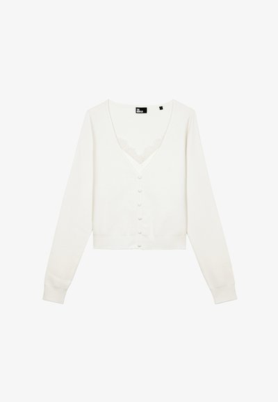 Hvid cardigan med V-udskæring, lange ærmer og seks knapper. Har et blonderet detaljeret stykke under halsen. Blødt strikmateriale.