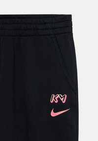 Crne trenirke od mješavine pamuka, sa ružičastim i žutim grafičkim logotipom, elastičnom kopčom u struku i bočnim džepovima.