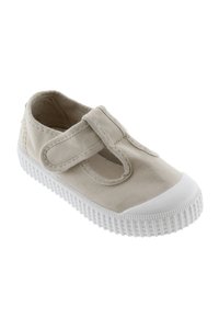 Scarpa in tela beige con suola in gomma bianca, caratterizzata da una punta arrotondata e una fascia in velcro per una chiusura sicura.