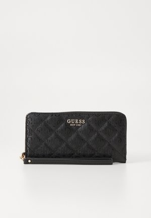 Portafoglio sintetico trapuntato nero con logo dorato "GUESS EST 1981". Design slim con chiusura a zip e tracolla staccabile.