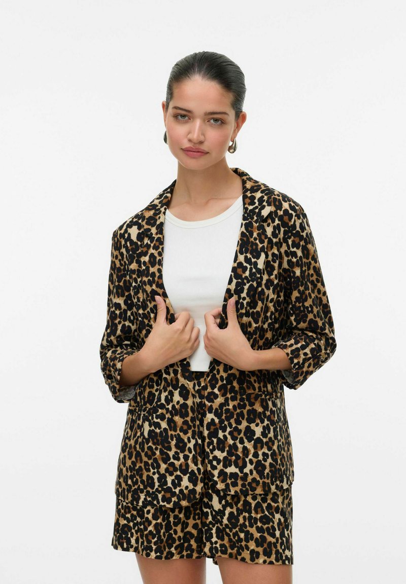 Blazer a kraťasy s leopardím potiskem, s béžovým pozadím a tmavě hnědými skvrnami, vyrobené z lehkého materiálu, s šálovým límcem a předními kapsami.
