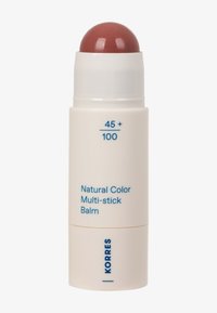 Natürlicher Farb-Multi-Stick-Balsam in einem beigen Drehstifftube mit sichtbar gerundetem braunem Balsam, beschriftet mit "45+ / 100" und dem Markennamen Korres in Blau.