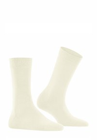 Calzini in cotone color crema chiaro con una texture liscia, bordo a costine, lunghezza alla caviglia standard e design senza cuciture sulla punta.